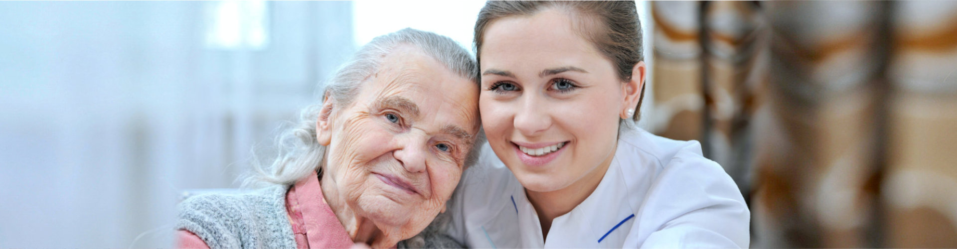 senior woman with caregiver smiling