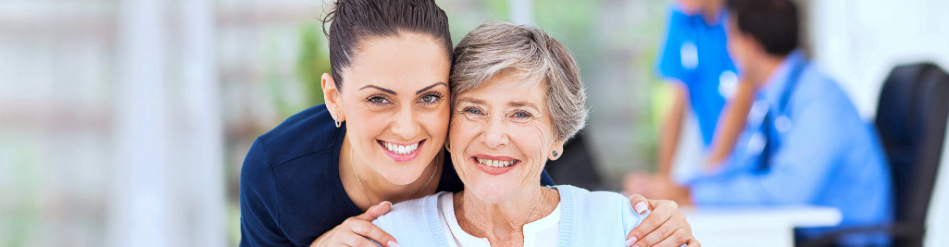 caregiver with senior woman smiling