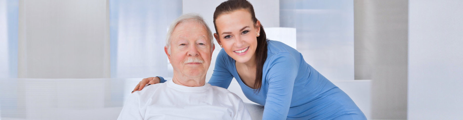 senior man smiling with caregiver