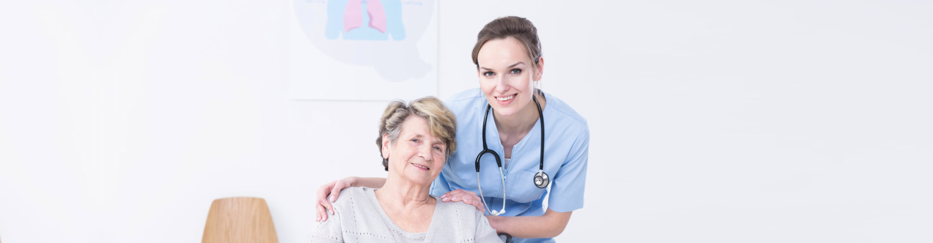 Young nurse standing behind the elder women